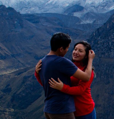J&M novios mirandose tiernamente en un paisaje natural.